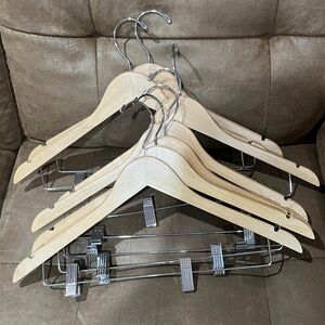 Set of 7 wooden hangers. Has clips for pants